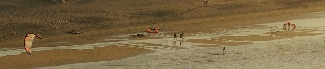Kitesurfing on the beach at dusk